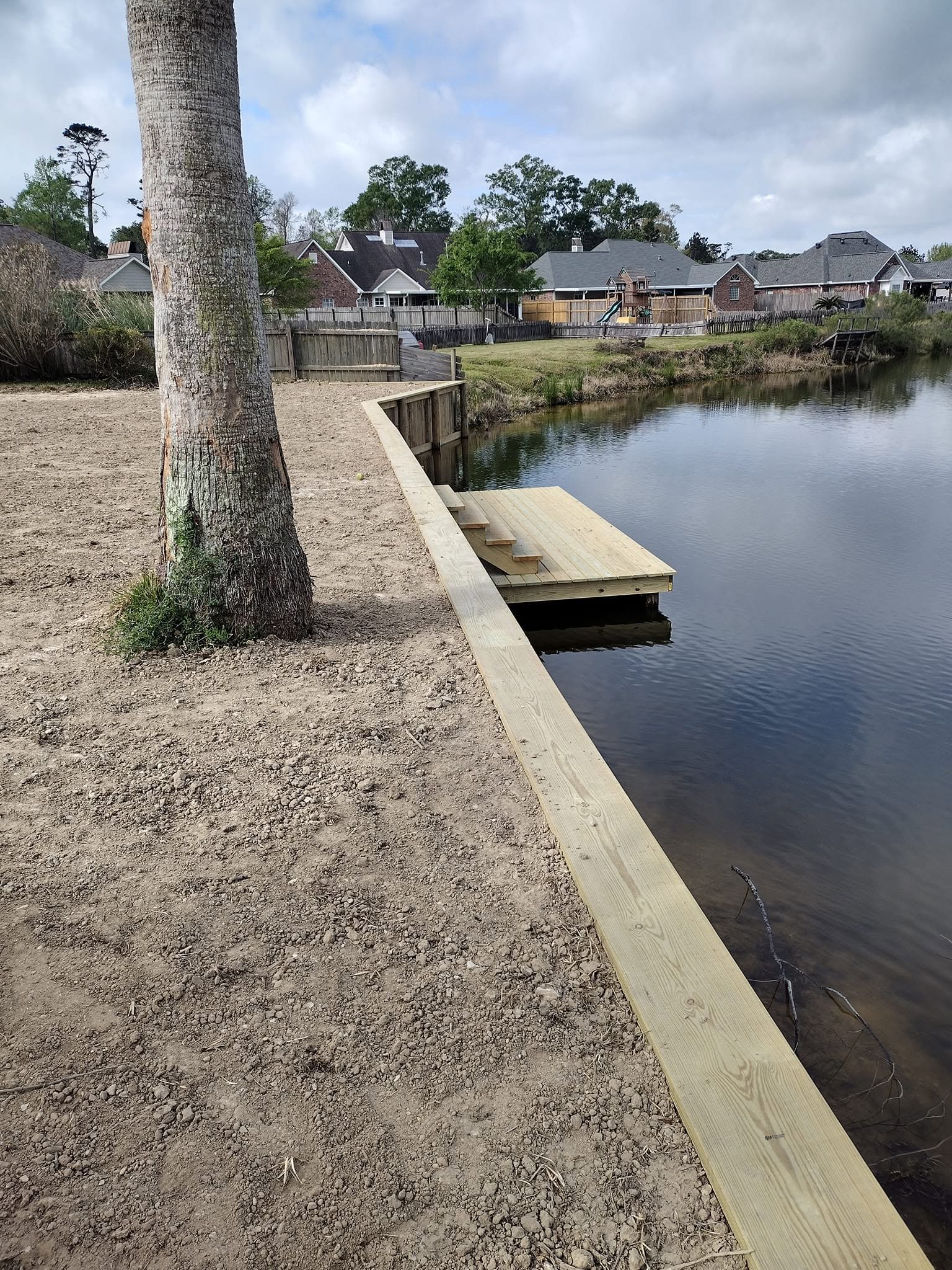 Backyard canal bulkhead and small dock protecting a waterfront lot in Southeast Louisiana