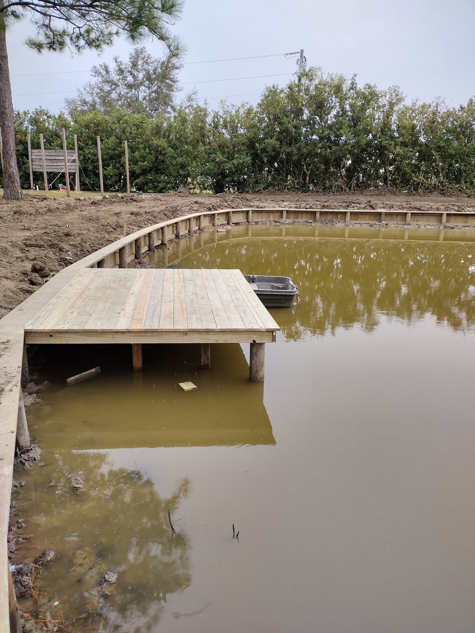Treated pine boat dock and curved bulkhead built along a Louisiana bayou