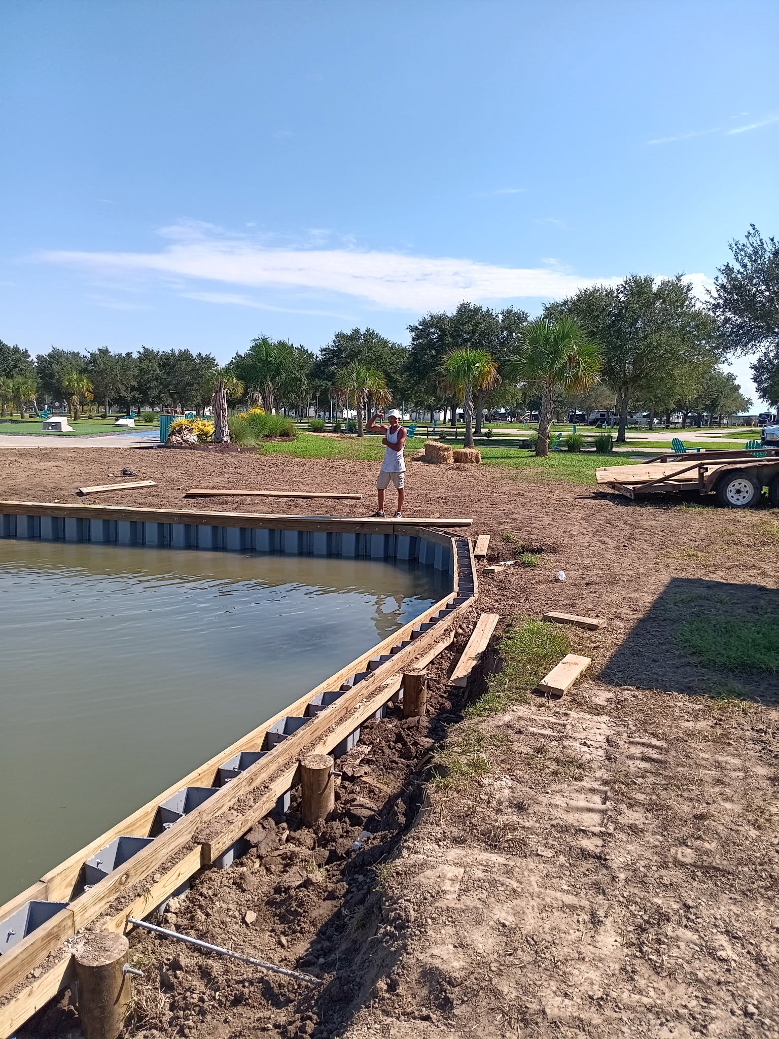 Installing sheet pile bulkhead on a lake shoreline, South Louisiana Crew member installing sheet pile bulkhead sections on a South Louisiana lake shoreline