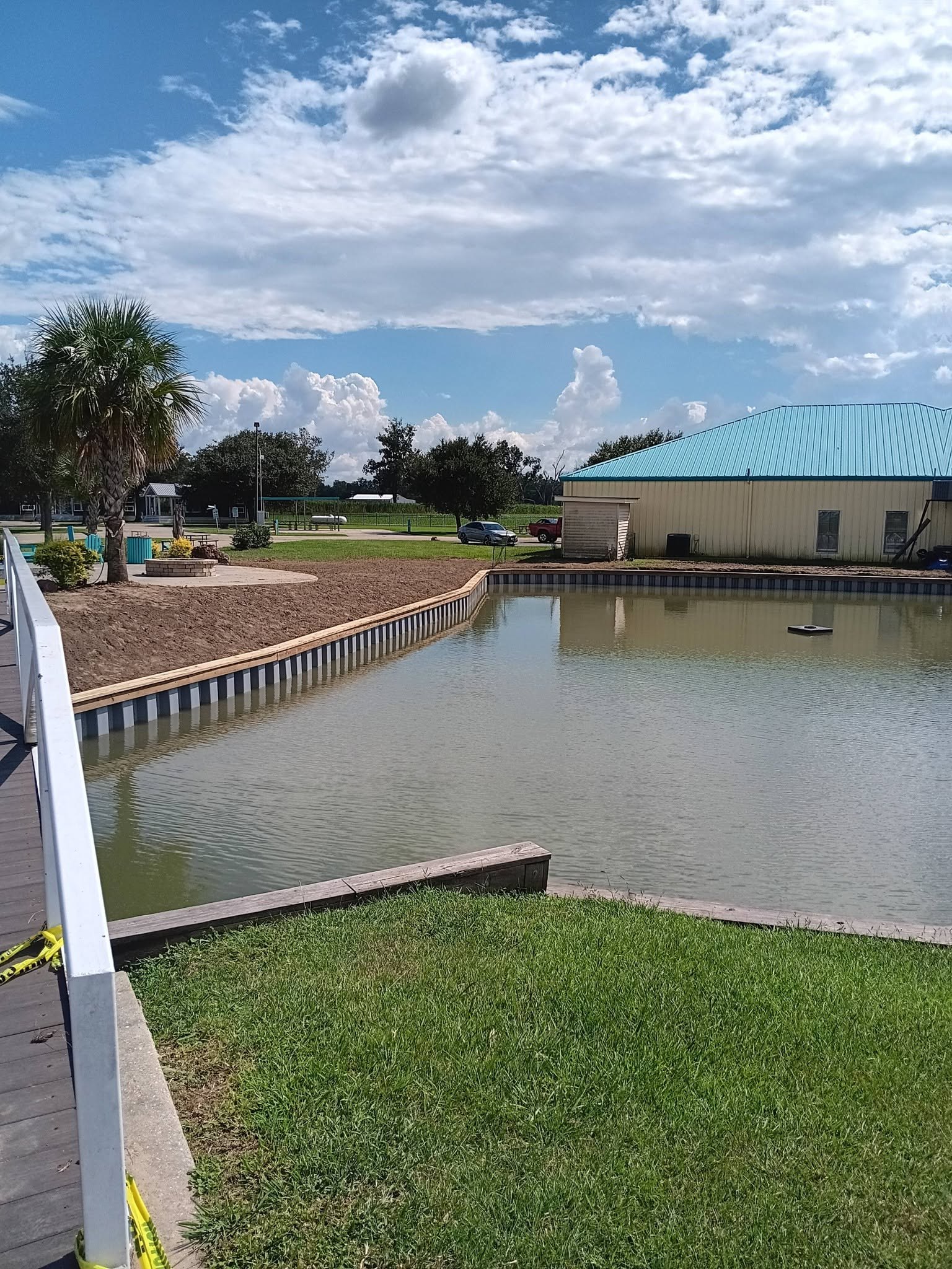 Commercial pond bulkhead with timber cap, South Louisiana Commercial pond bulkhead finished with a continuous treated timber cap at a South Louisiana park