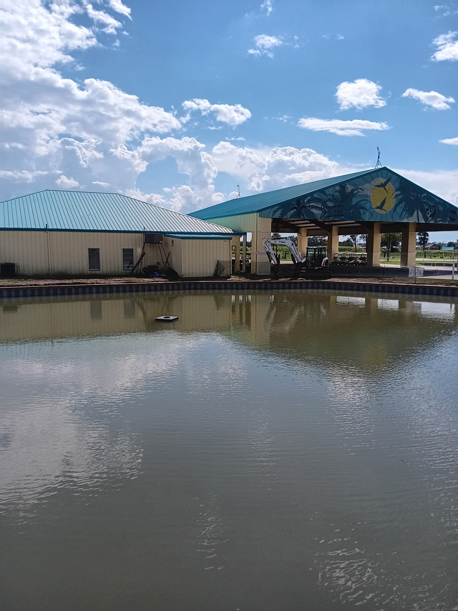Lakefront bulkhead protecting the bank in front of a covered pavilion in South Louisiana