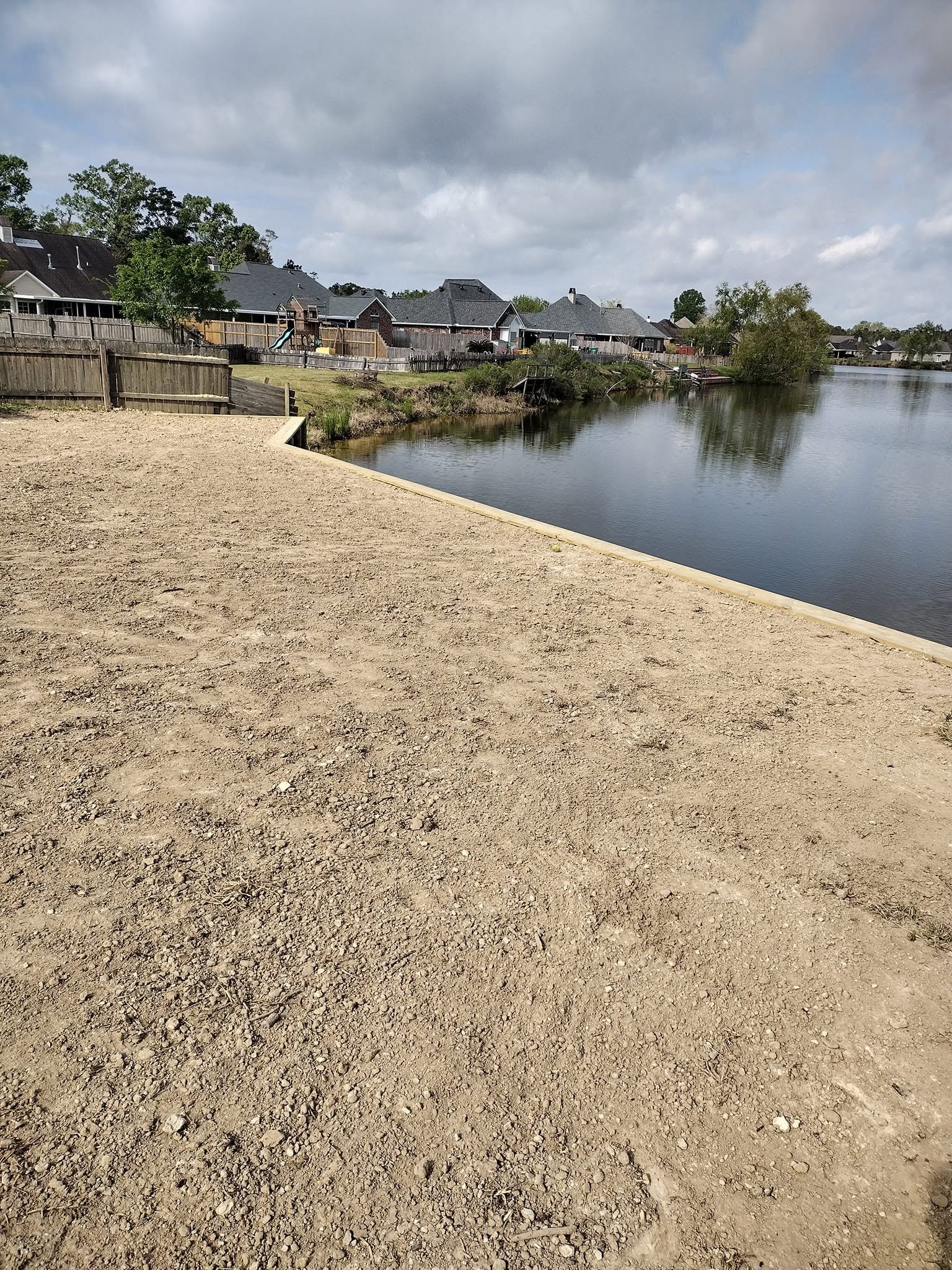 Residential canal bulkhead and regraded bank protecting a Louisiana subdivision waterfront